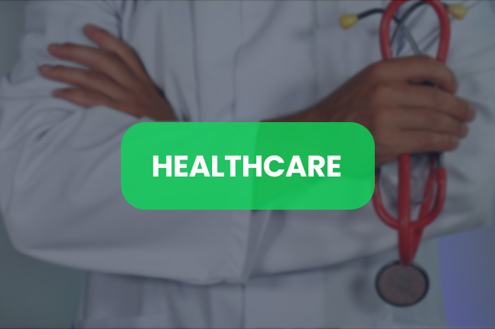 A doctor in scrubs holding a stethoscope representing one of our business sectors, healthcare